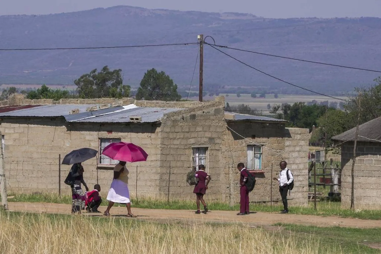 A group of school children from Ubusi Combined School play along the way as they prepare to embark on their walk back to their various homes at the end of the day near Dundee, South Africa, Thursday, Oct. 26, 2023. (AP Photo/ Sebabatso Mosamo)
