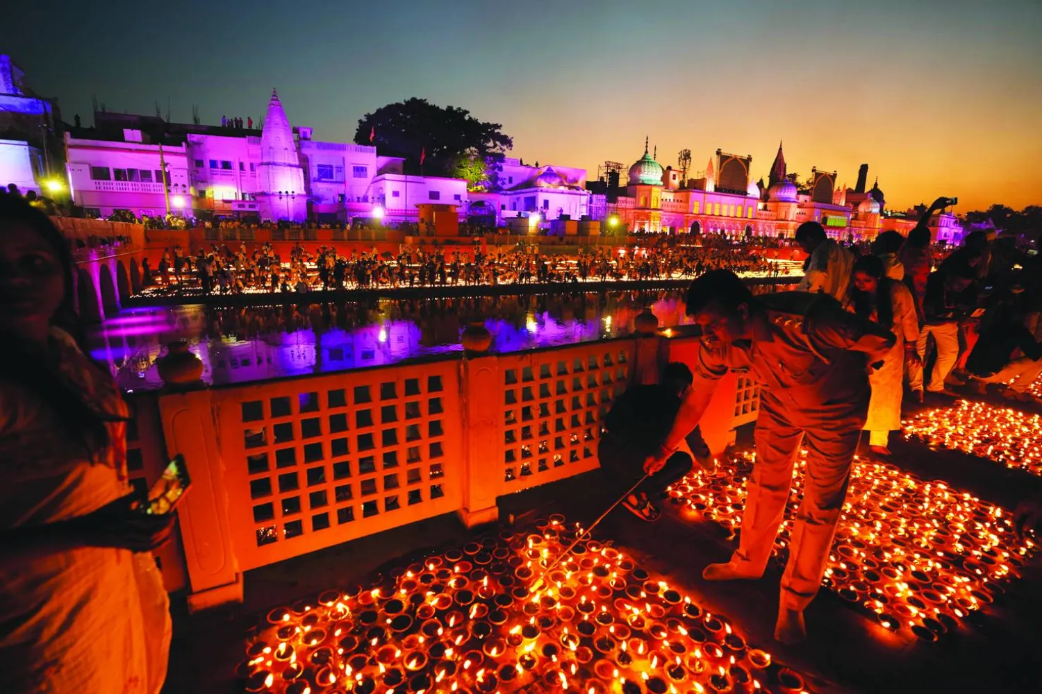 People light lamps on the banks of the river Saryu in Ayodhya, India, Sunday, Oct. 23, 2022. Over 15,00,000 earthen lamps were lit along the banks of the Saryu River, as millions of people across Asia celebrate Diwali, the Hindu festival of lights. (AP Photo/Rajesh Kumar Singh)