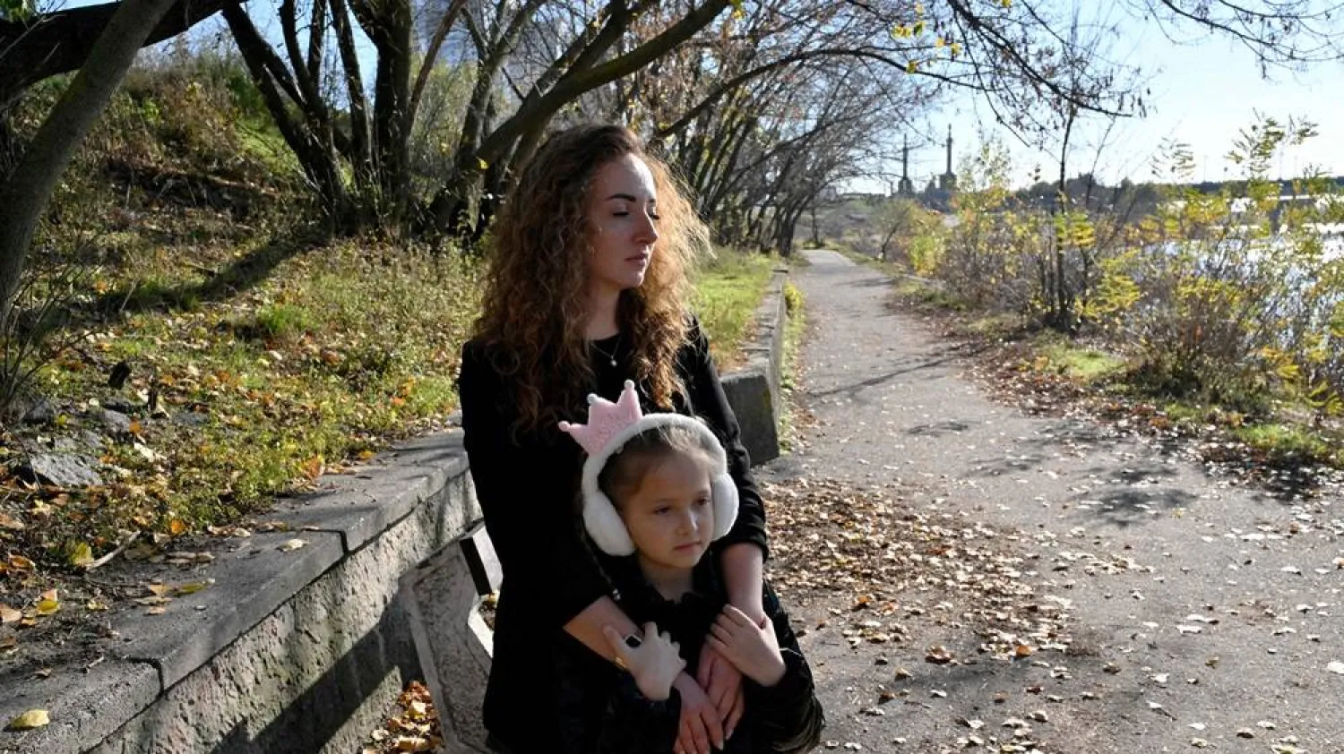  Anna Lyashko, 28, and her daughter Diana, 8, walk in a park near Dnipro river in Kyiv on November 3, 2023, amid the Russian invasion of Ukraine. (AFP)