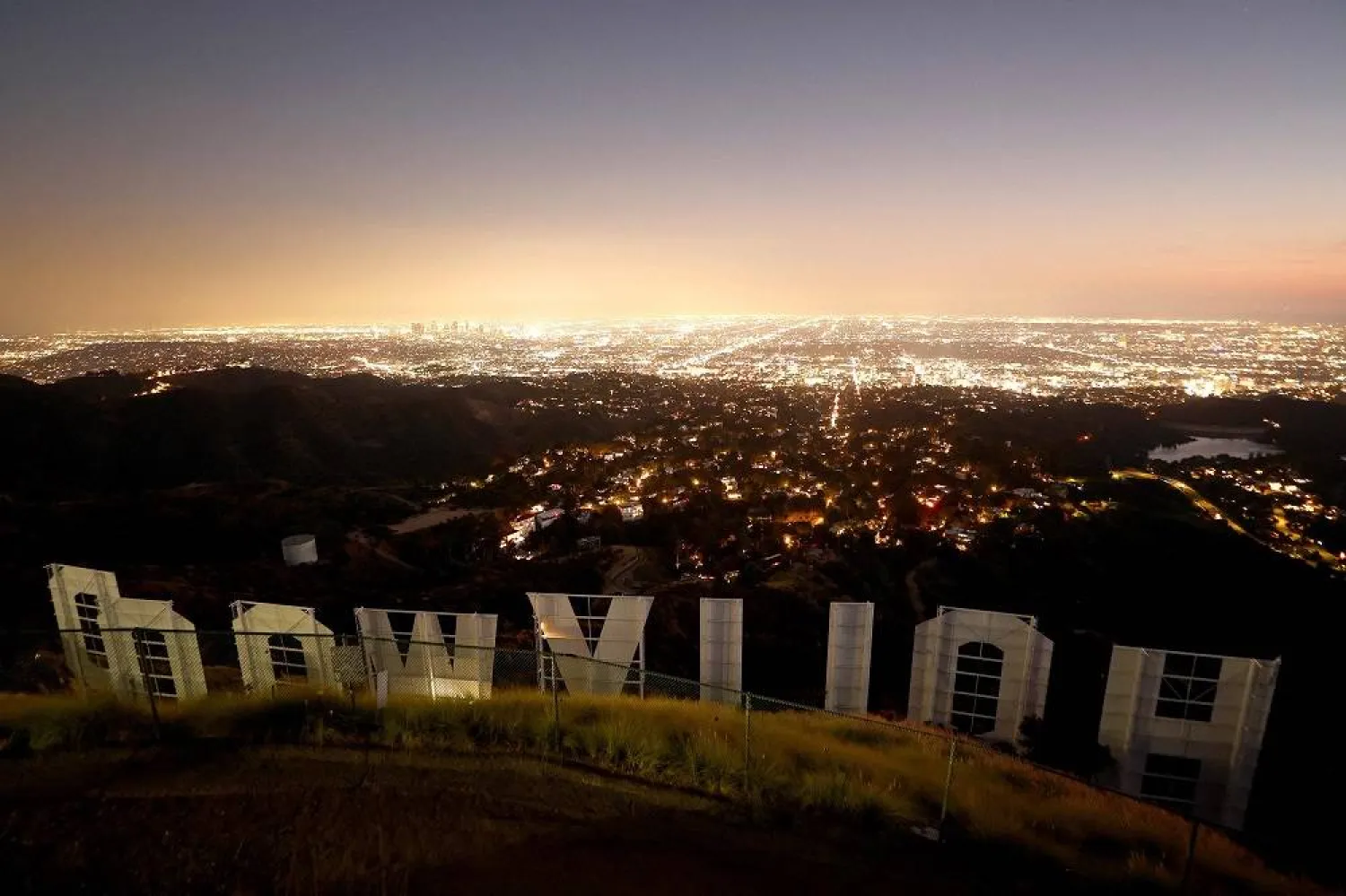 The Hollywood sign stands at dusk on day 106 of the SAG-AFTRA strike against the Hollywood studios on October 27, 2023 in Los Angeles, California. (Getty Images via AFP)
