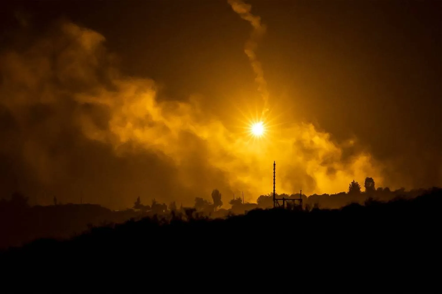 This picture taken from a position near Sderot along the Israeli border with the Gaza Strip on November 13, 2023, shows flares dropped by Israeli forces above the Palestinian territory amid ongoing battles between Israel and the Hamas movement. (AFP)