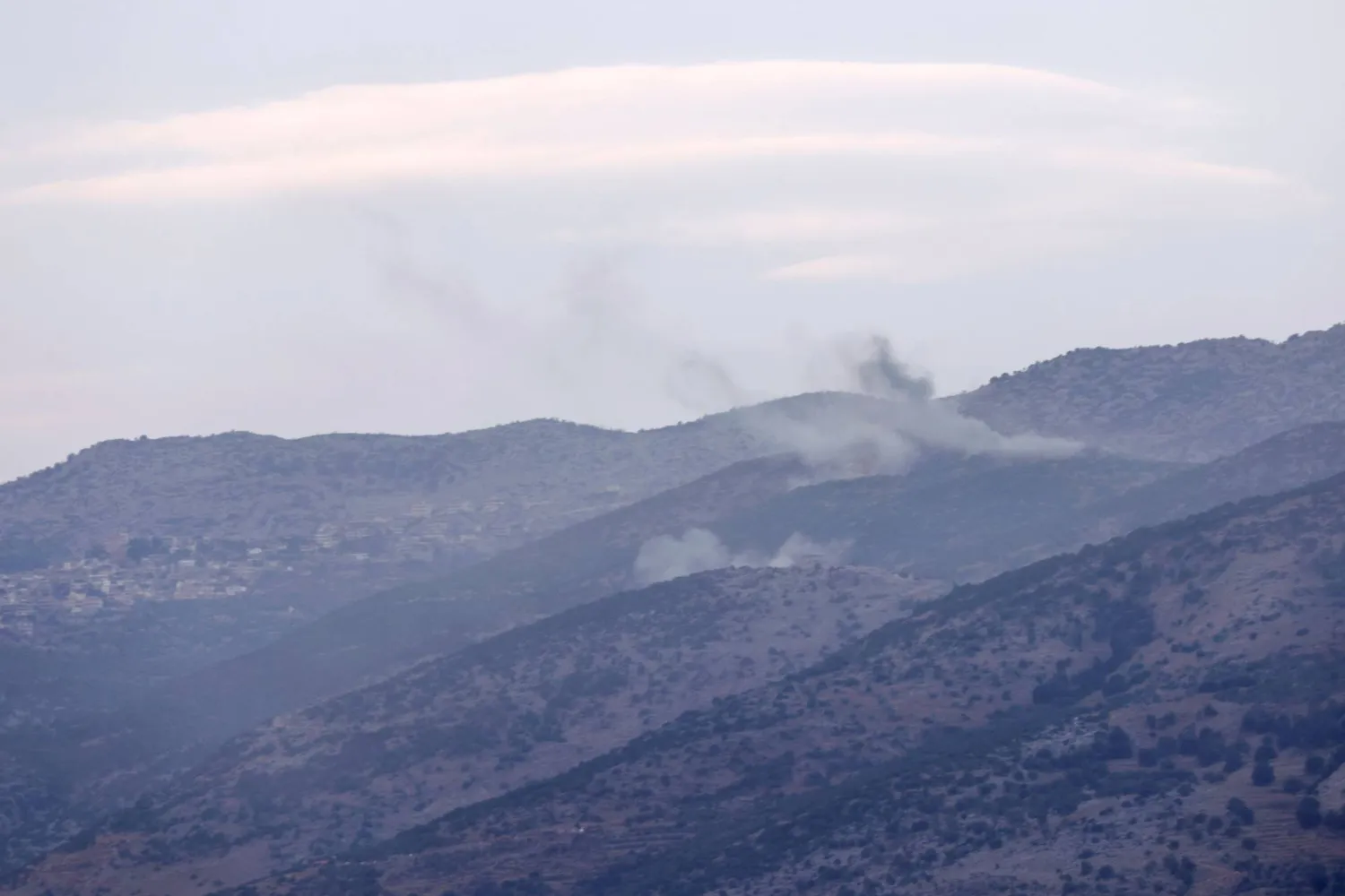 A picture taken from the Israeli side shows smoke billowing following Israeli shelling on the Lebanese side of the disputed Shebaa Farms district on November 13, 2023, amid increasing cross-border tensions with Lebanon's Hezbollah as fighting continues with Hamas militants in the southern Gaza Strip. (Photo by Jalaa MAREY / AFP)