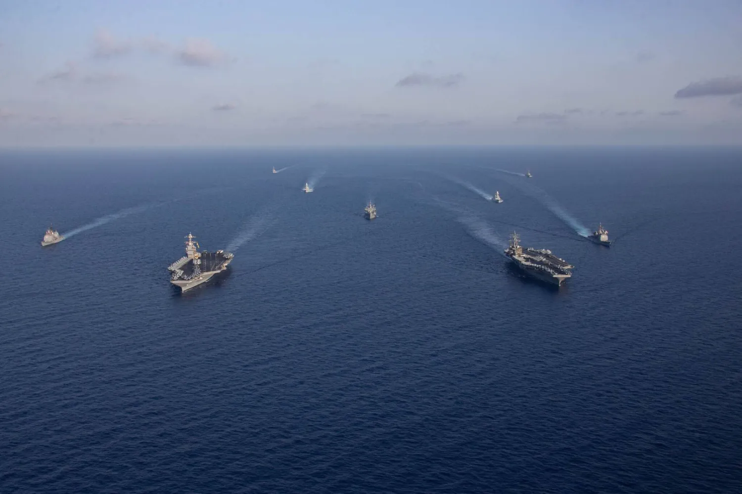 In this photo obtained from the US Department of Defense, the aircraft carriers Gerald R. Ford (L, front) and Dwight D. Eisenhower (R, front) and ships in their Strike Groups sail in formation in the Mediterranean Sea, on November 3, 2023. (AFP)