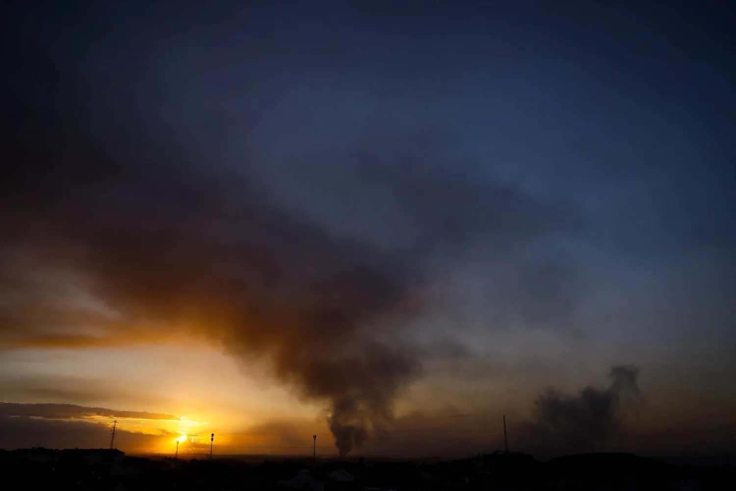 This picture taken from a position along the border with the Gaza Strip in southern Israel shows a smoke plume erupting during Israeli bombardment on the Palestinian territory, on November 15, 2023. (Photo by KENZO TRIBOUILLARD / AFP)