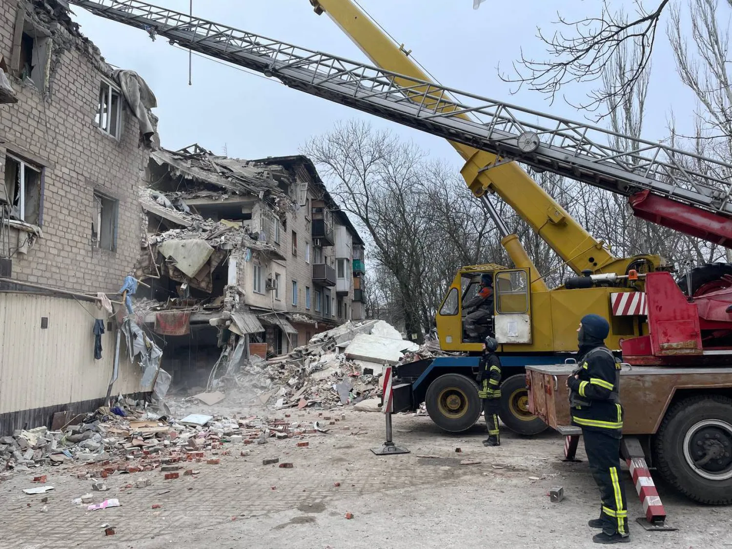 This handout picture taken and released on November 16, 2023 by Ukrainian Emergency Service shows rescuers clearing debris of a residential building damaged after a Russian strike in Selydove, Donetsk region. As a result of the missile strike four people were killed and three people were injured, Emergency Service announced. (Photo by Handout / AFP) 