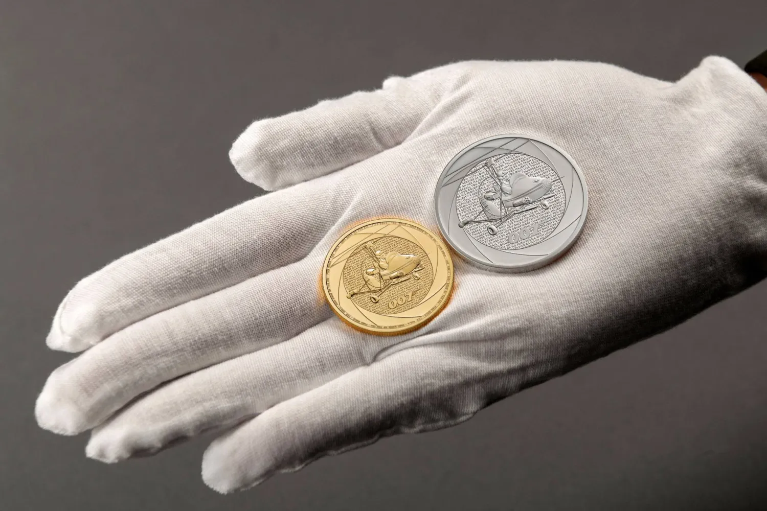 An undated handout picture released by the Royal Mint, received in London on November 15, 2023 shows the reverse of gold and silver bullion James Bond-themed coins unveiled to celebrate six decades of 007. (Photo by Royal Mint / AFP)