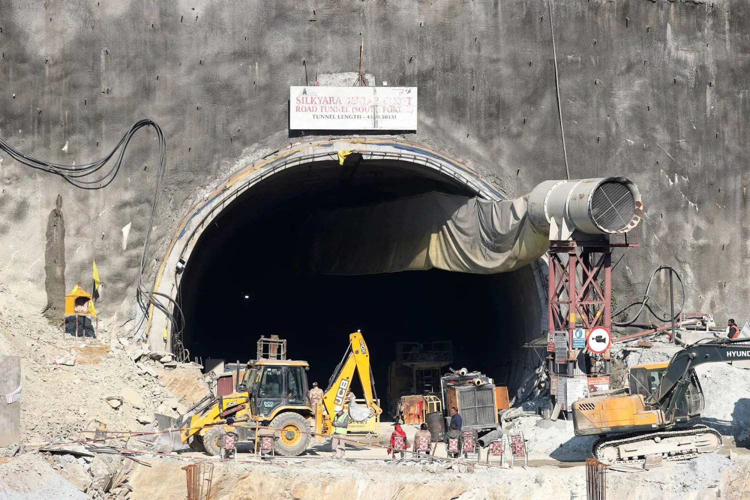 Workers gather near the site of a tunnel collapse on the Brahmakal Yamunotri National Highway in Uttarkashi, India, 25 November 2023. EPA/HARISH TYAGI