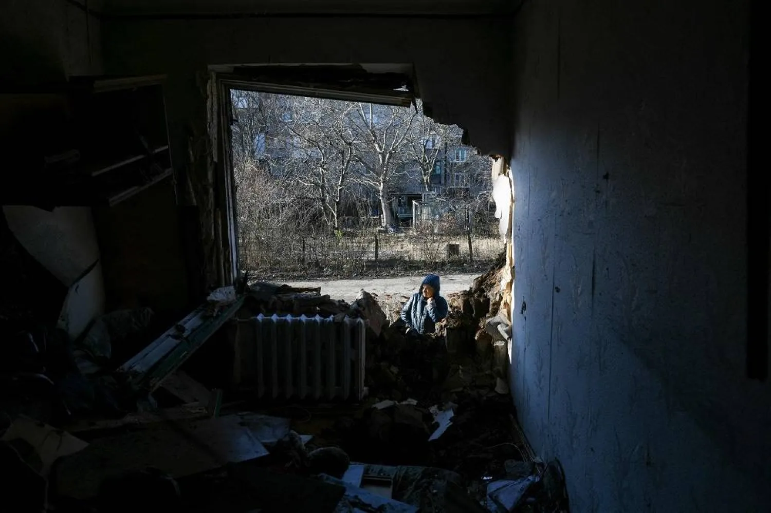 A local resident stands outside an apartment building damaged by recent shelling in Donetsk, Russian-controlled Ukraine, on November 28, 2023, amid the Russia-Ukraine conflict. (AFP)