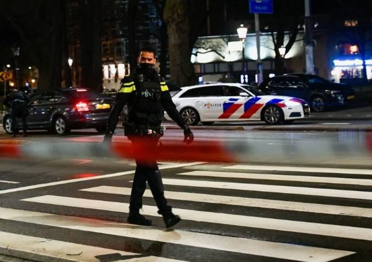 A police officer walks near an Apple store in central Amsterdam during a hostage incident in the store, in Amsterdam, Netherlands February 22, 2022. REUTERS/Piroschka van de Wouw