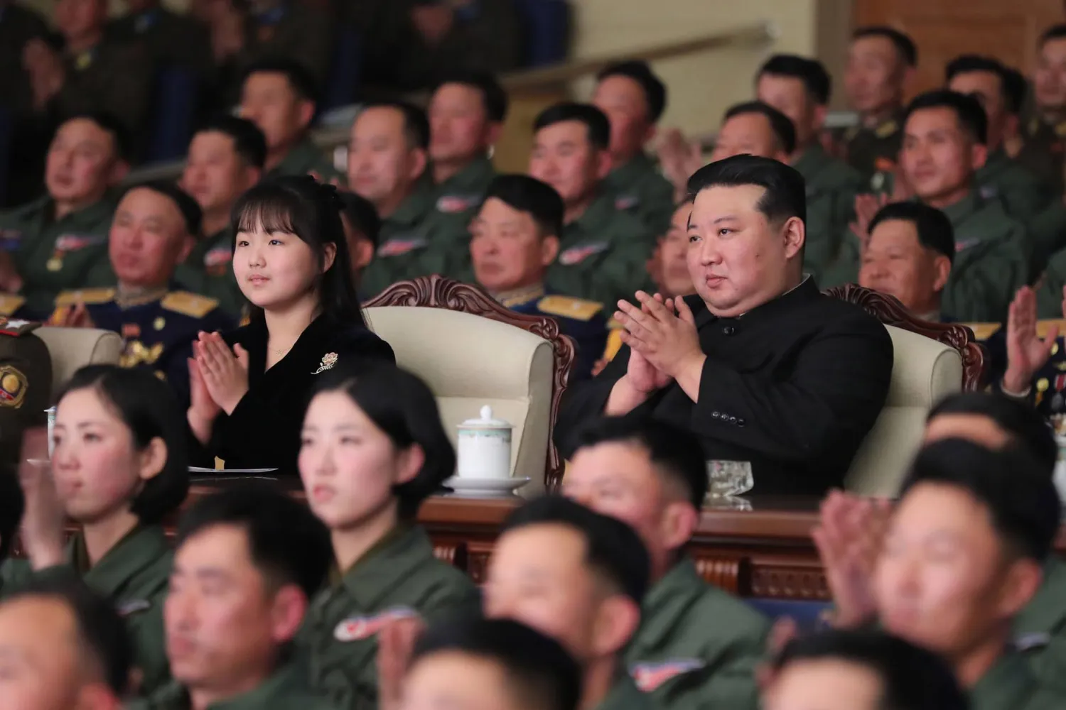 HANDOUT - 30 November 2023, North Korea: A picture released by the North Korean state news agency (KCNA) on 1 December 2023 shows North Korean leader Kim Jong-un (R) and his daughter attending a ceremony as they visit the Korean People's Army's 1st Army Division Flight Regiment to commemorate the Air Force Day. Photo: -/kcna/dpa 