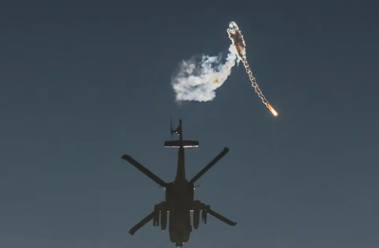 An Israeli military helicopter releases a flare over the Israel-Gaza border, after a temporary truce between Israel and the Palestinian group Hamas expired, as seen from southern Israel, December 1, 2023. REUTERS/Amir Cohen Acquire Licensing Rights



