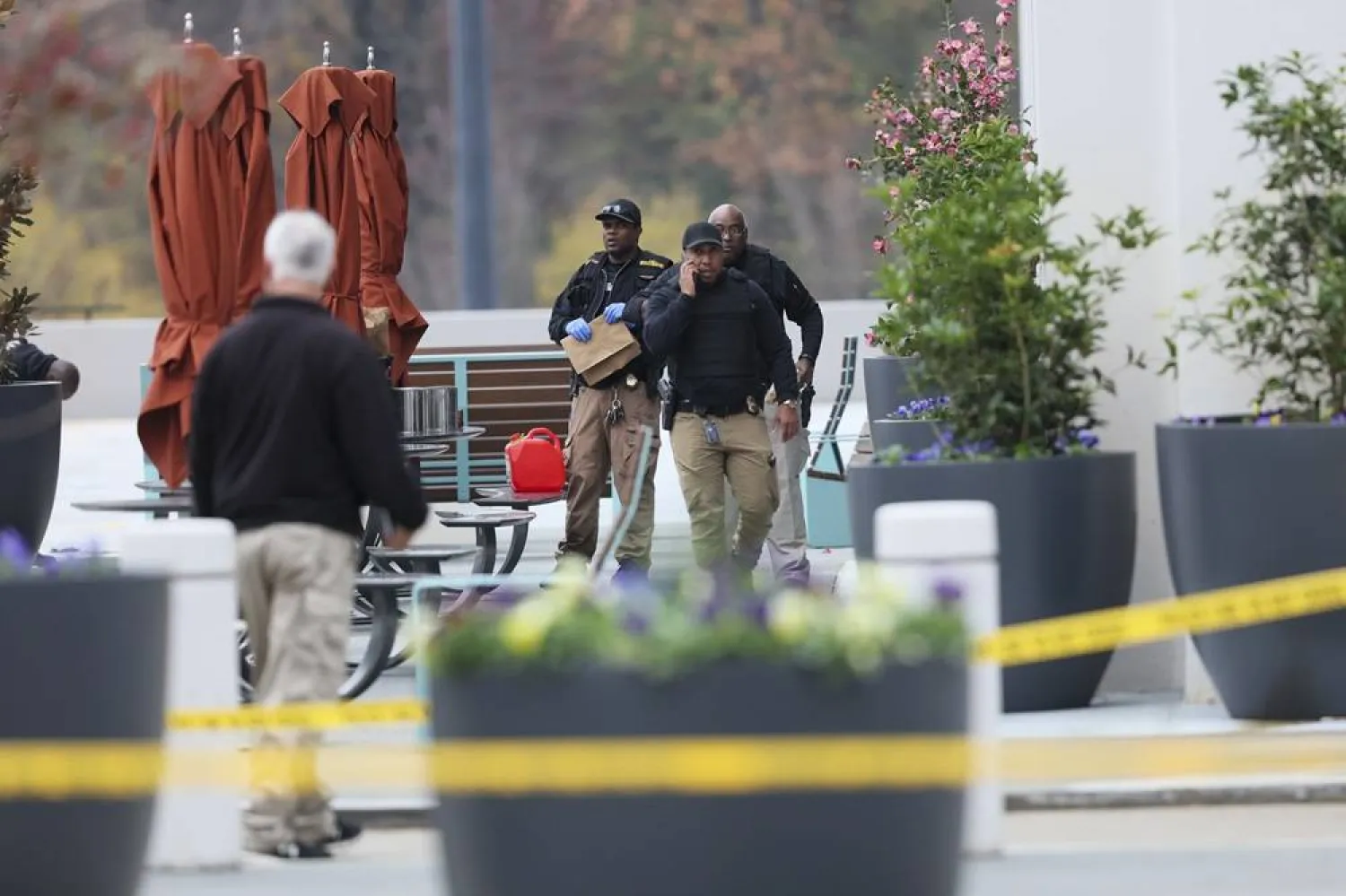  Emergency personnel work the scene after a protester set themself on fire outside the Israeli consulate in Atlanta, Friday, Dec. 1, 2023. (Atlanta Journal-Constitution via AP) 