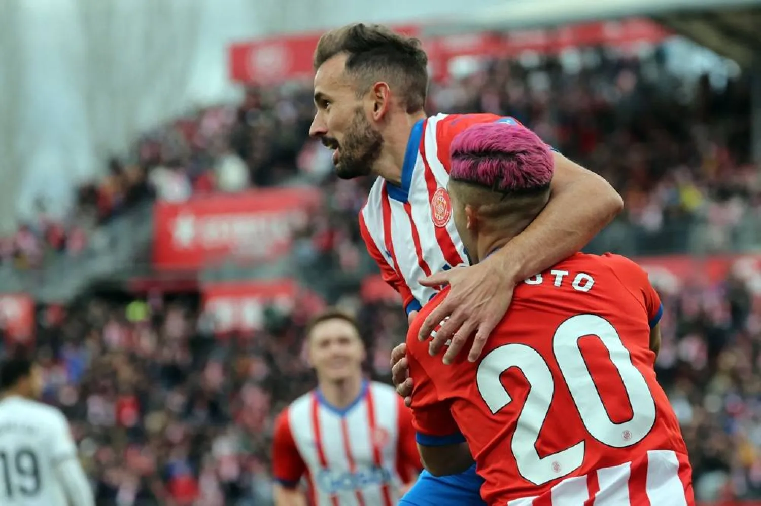 Girona's Uruguayan forward #07 Cristhian Stuani and Girona's Brazilian defender #20 Yan Couto celebrate their team's second goal during the Spanish league football match between Girona FC and Valencia CF at the Montilivi stadium in Girona on December 1, 2023. (AFP)