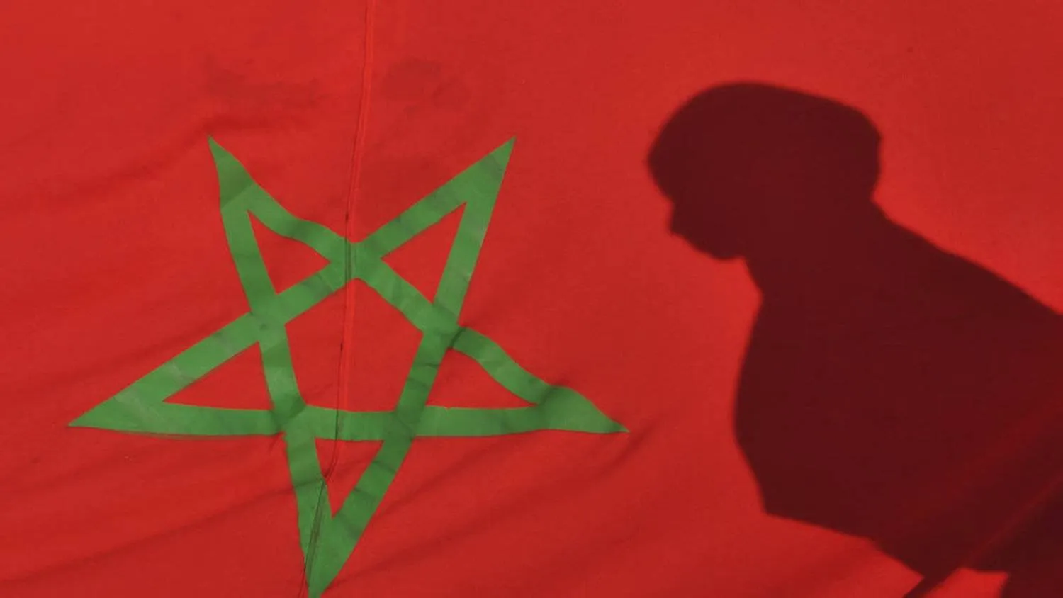 Morocco's flag with a woman's shadow seen on it. AFP file photo