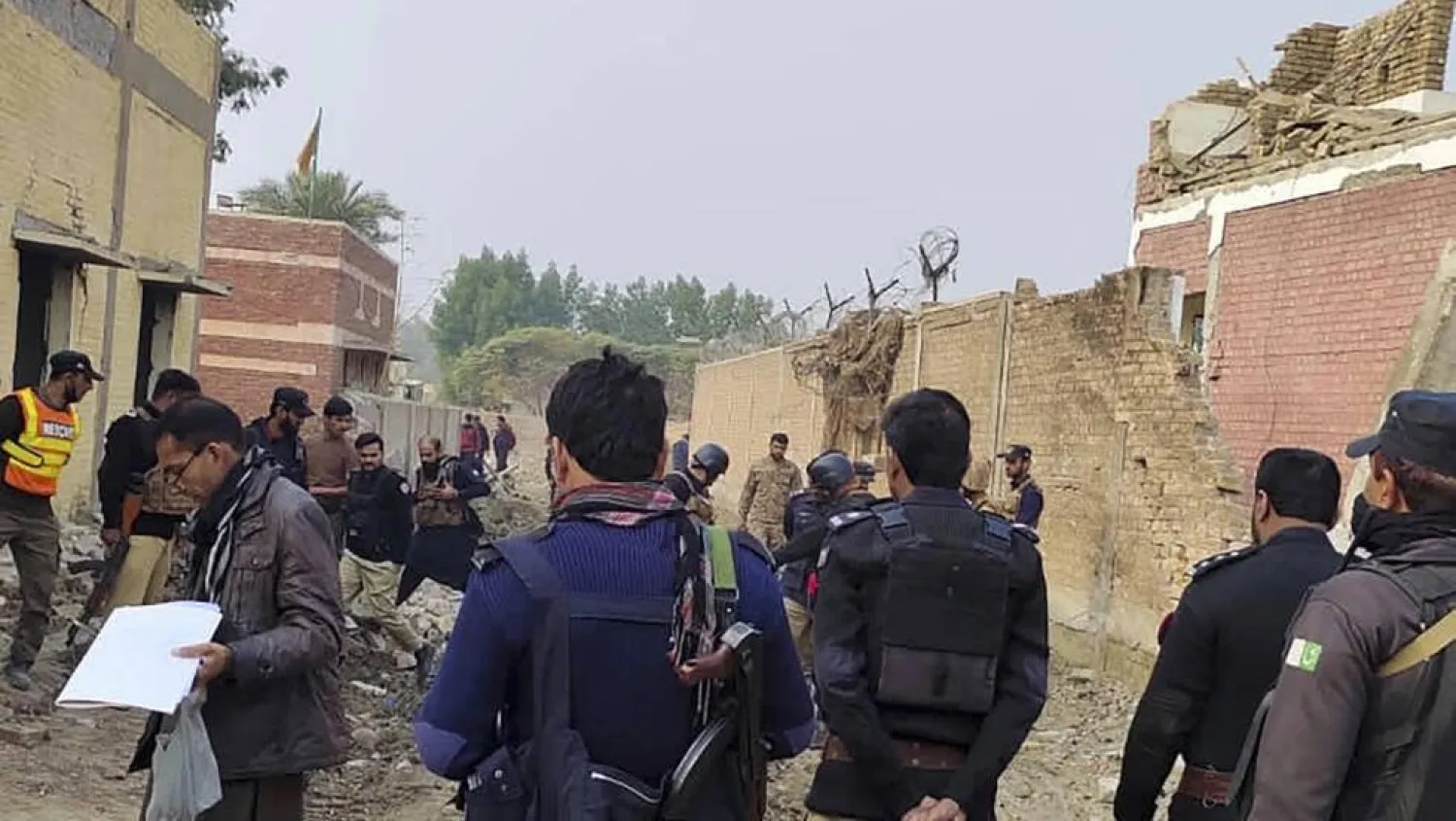 Security officials examine damage at the site of a bombing on the outskirts of Dera Ismail Khan, Pakistan on Tuesday, December 12, 2023. AP
