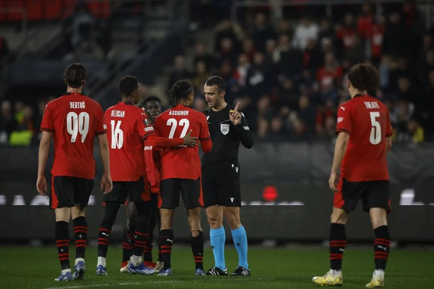 Turkish referee Atilla Karaoglan discusses with Rennes's Lorenz Assignon during the UEFA Europa League Group F soccer match between Rennes and Villarreal in Rennes, France, 14 December 2023. (EPA)