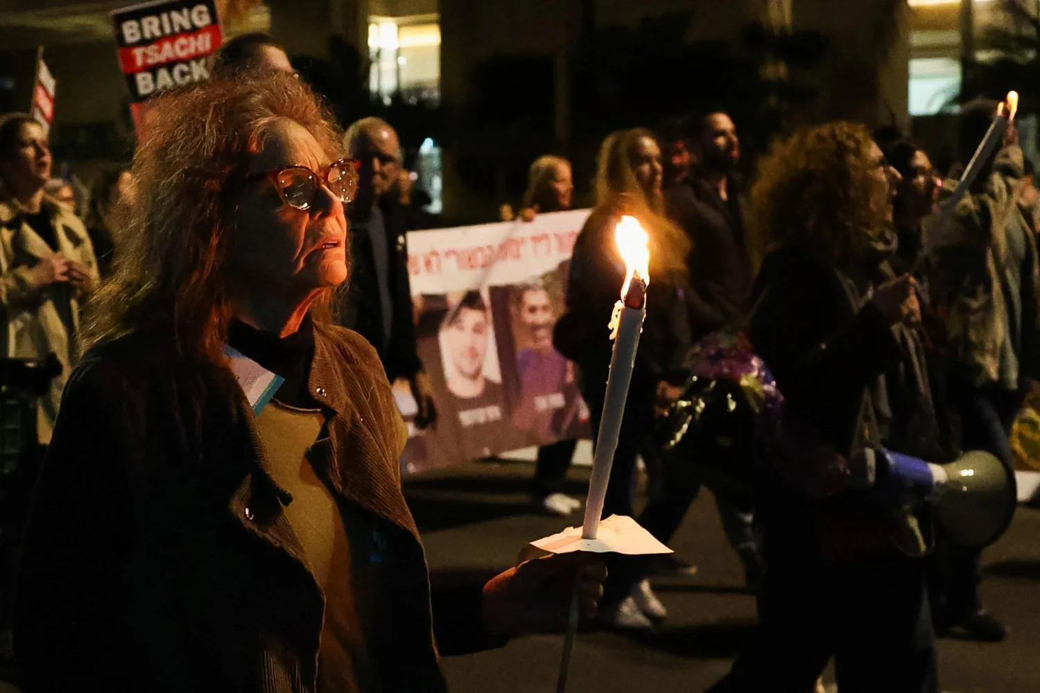 A woman holds a candle as people protest following an announcement by Israel's military that they had mistakenly killed three Israeli hostages being held in Gaza by Palestinian Hamas, at a demonstration in Tel Aviv, Israel, December 15, 2023. REUTERS/Violeta Santos Moura/File Photo Acquire Licensing Rights



