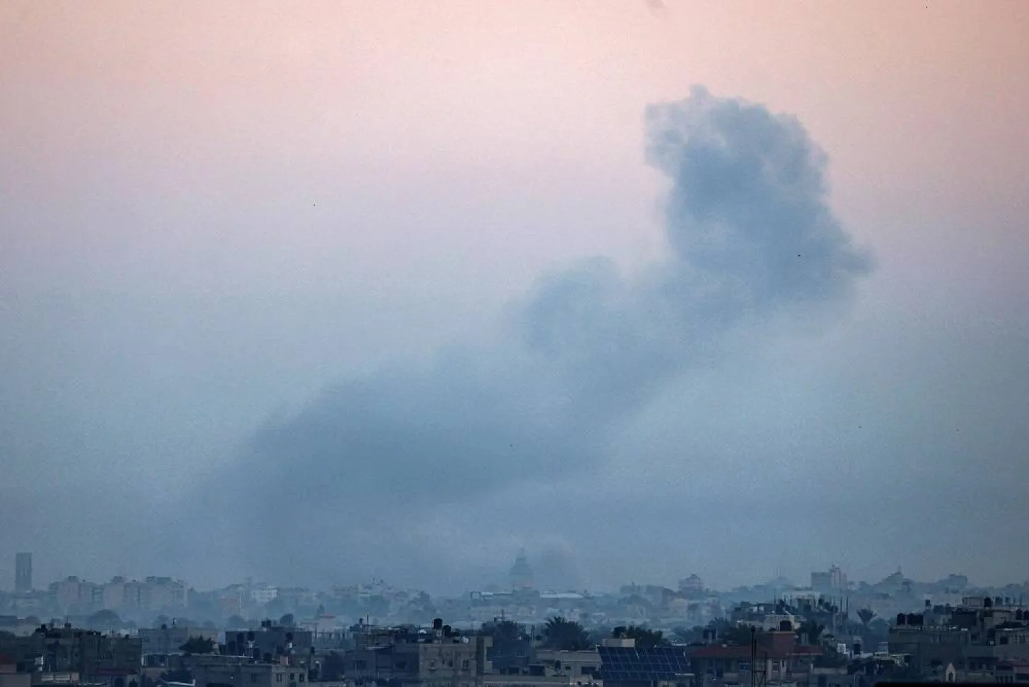 A picture taken from Rafah shows smoke billowing over Khan Younis in the southern Gaza Strip during Israeli bombardment on December 19, 2023, amid continuing battles between Israel and the Palestinian militant group Hamas. (AFP)