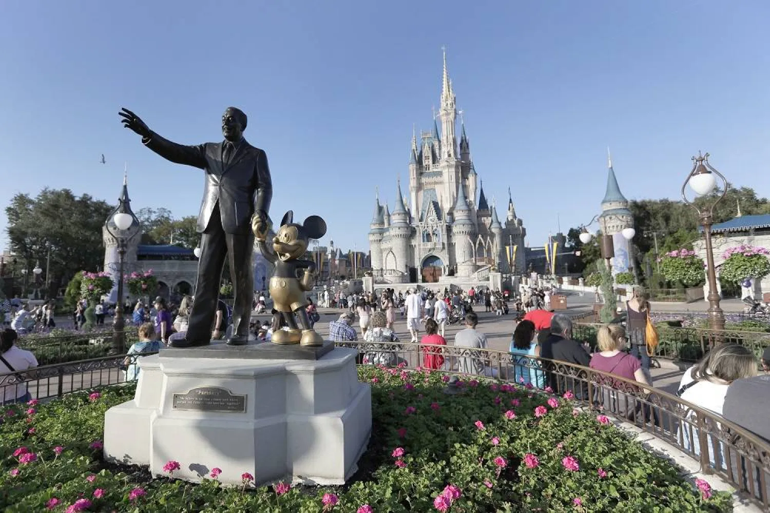 A statue of Walt Disney and Mickey Mouse appears in front of the Cinderella Castle at the Magic Kingdom theme park at Walt Disney World, Jan. 15, 2020, in Lake Buena Vista, Fla. (AP)