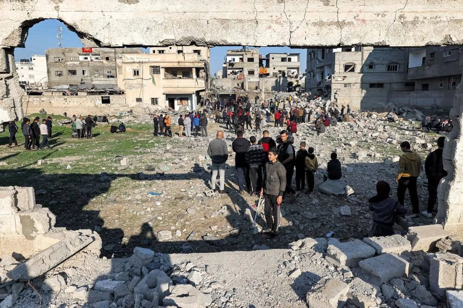 People gather to inspect the rubble of a building destroyed by Israeli bombardment in Rafah in the southern Gaza Strip on December 19, 2023 amid continuing battles between Israel and the militant group Hamas. (AFP)