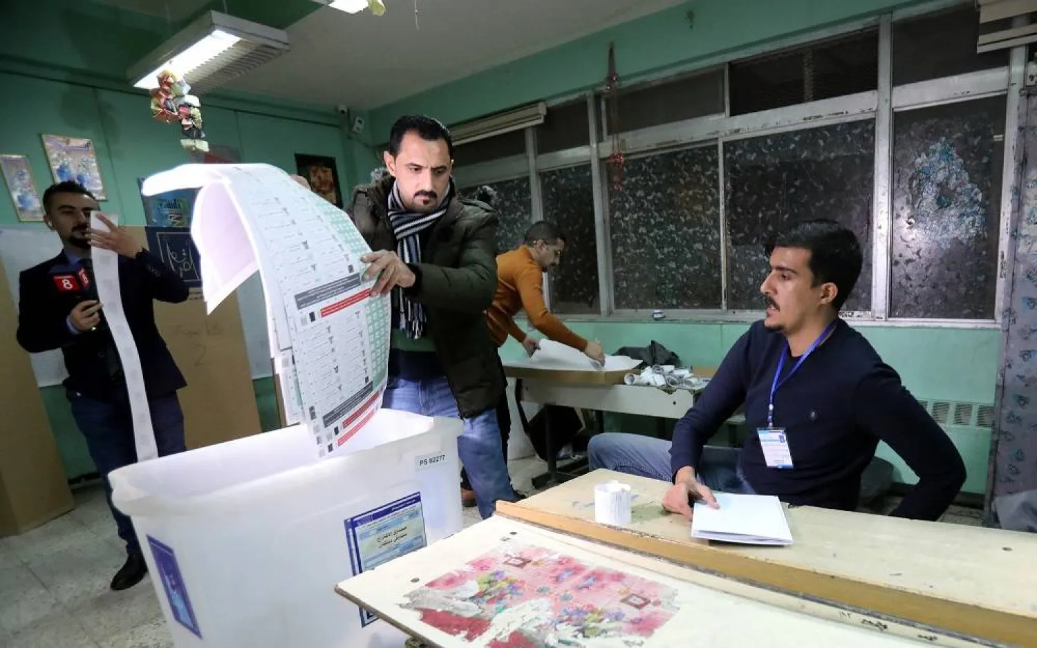 Election committee staff members count the votes at the end of the provincial election day at a polling station in Karada district, Baghdad, Iraq, 18 December 2023. (EPA)