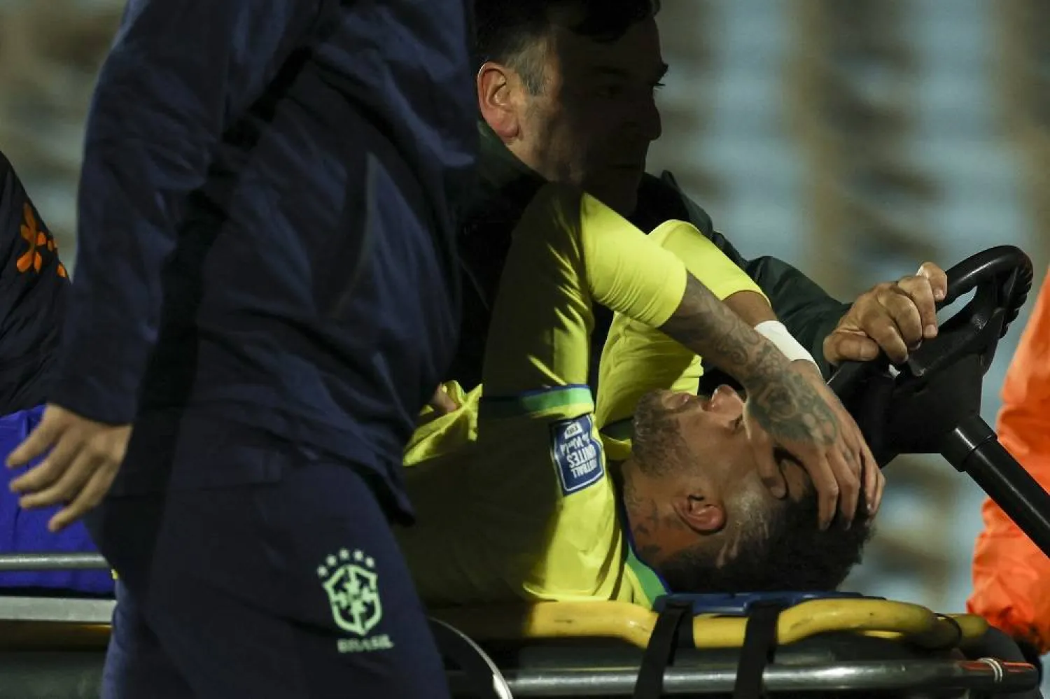Brazil's forward Neymar leaves the field crying in pain after an injury during the 2026 FIFA World Cup South American qualification football match between Uruguay and Brazil at the Centenario Stadium in Montevideo on October 17, 2023. (AFP)