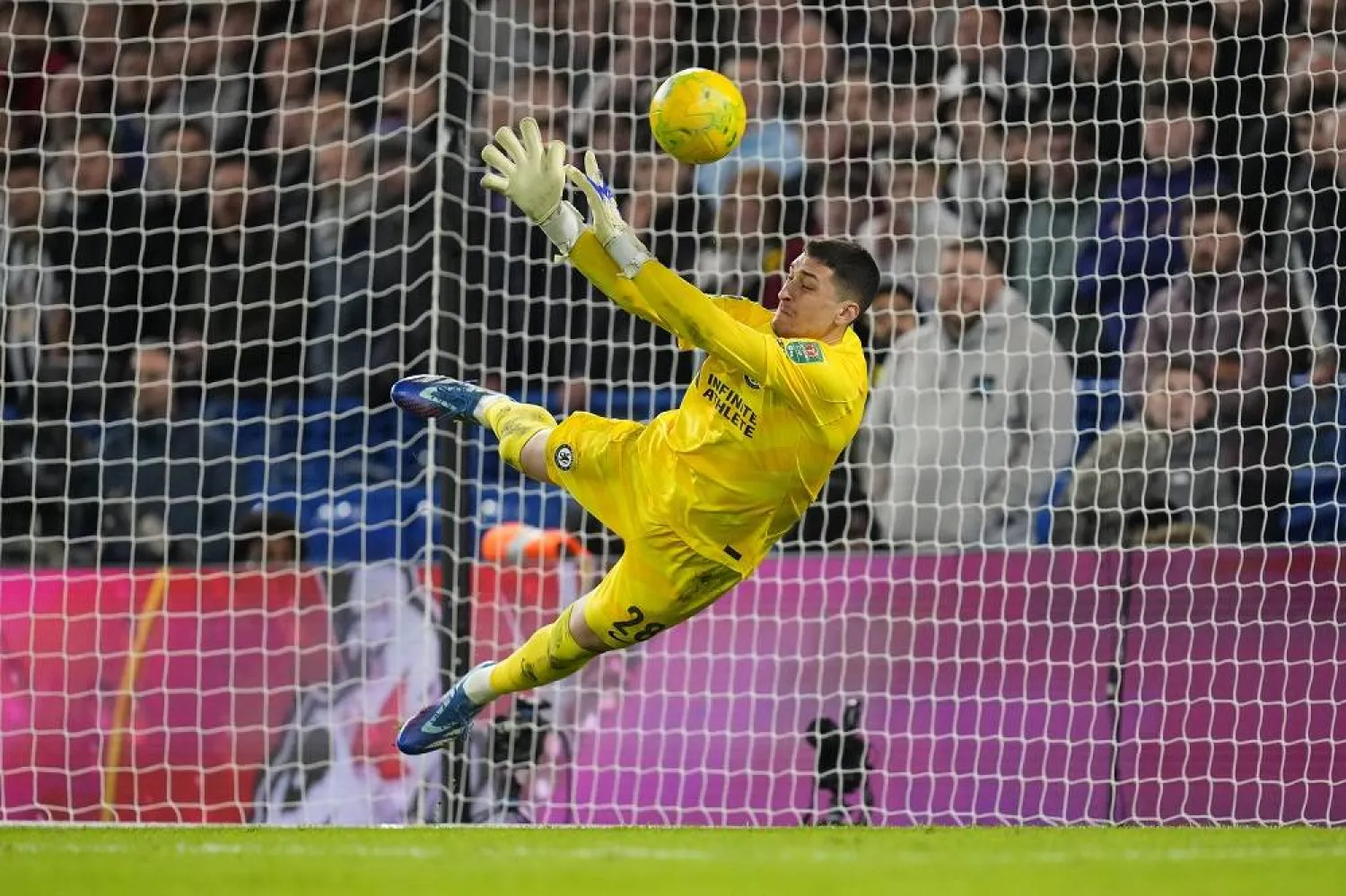 Chelsea's goalkeeper Djordje Petrovic saves a shot from Newcastle's Matt Ritchie during a penalty shoot out during the English League Cup quarterfinal soccer match between Chelsea and Newcastle United at Stamford Bridge in London, Tuesday, Dec. 19, 2023. (AP)