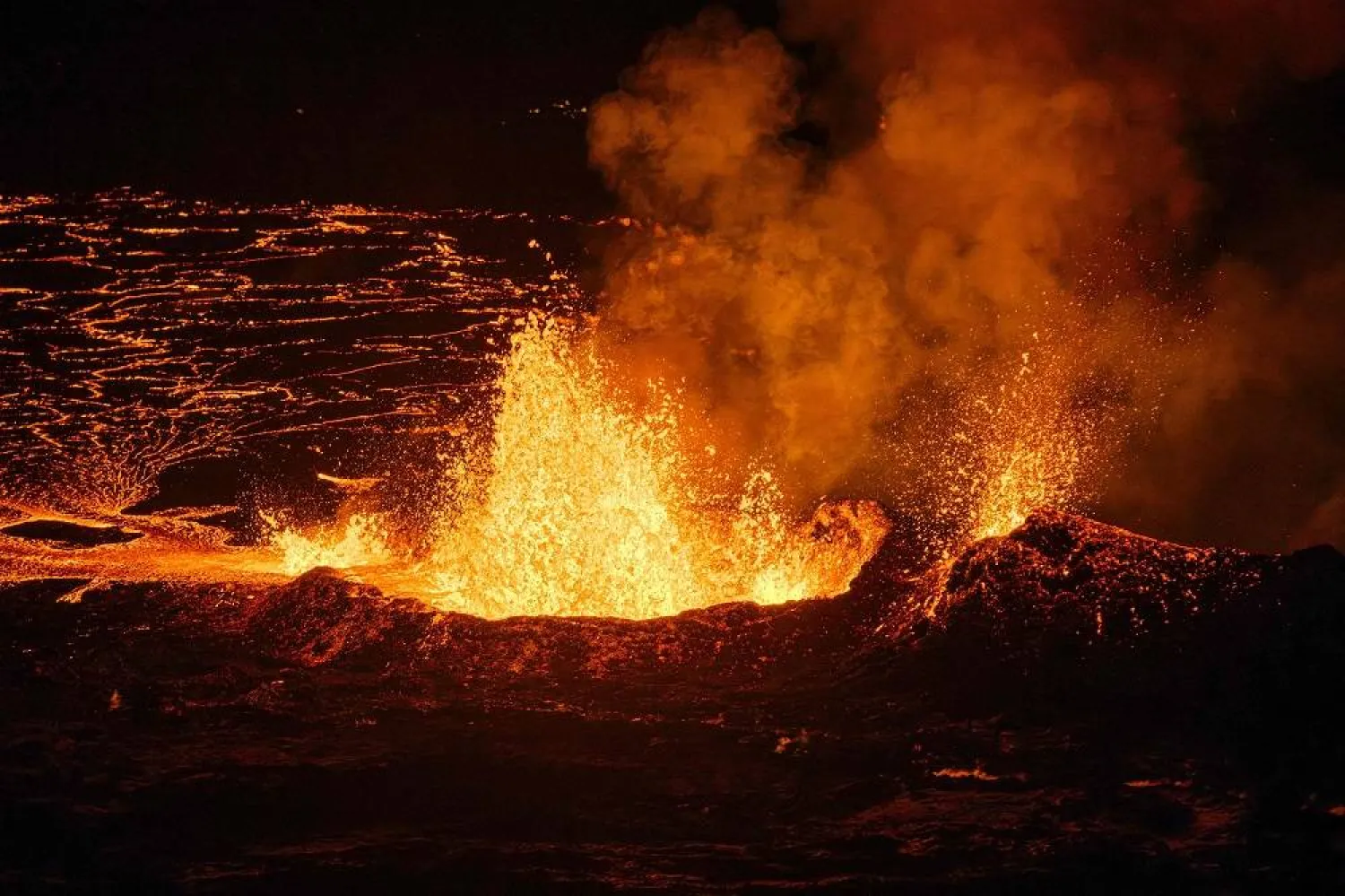 Molten lava is coming out from a fissure on the Reykjanes peninsula 3km north of the evacuate town of Grindavik, western Iceland on December 19, 2023. (AFP)