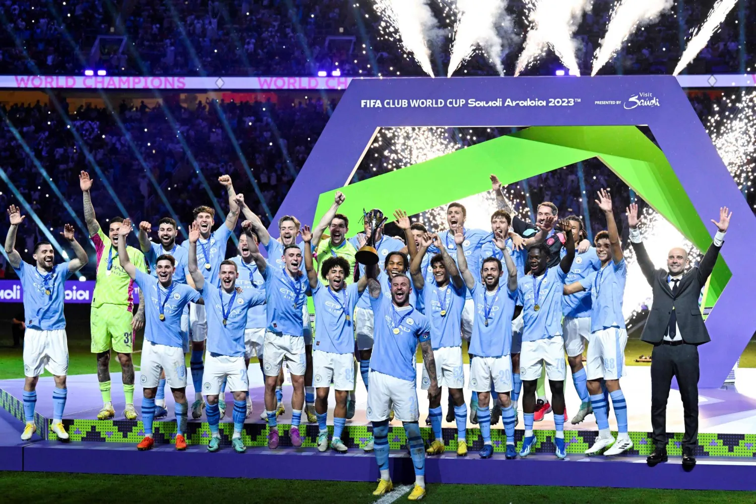 22 December 2023, Saudi Arabia, Jeddah: Manchester City players celebrate with the trophy after the final whistle of the FIFA Club World Cup final soccer match between Manchester City FC and Fluminense FC at King Abdullah Sports City Stadium. Photo: -/Saudi Press Agency/dpa