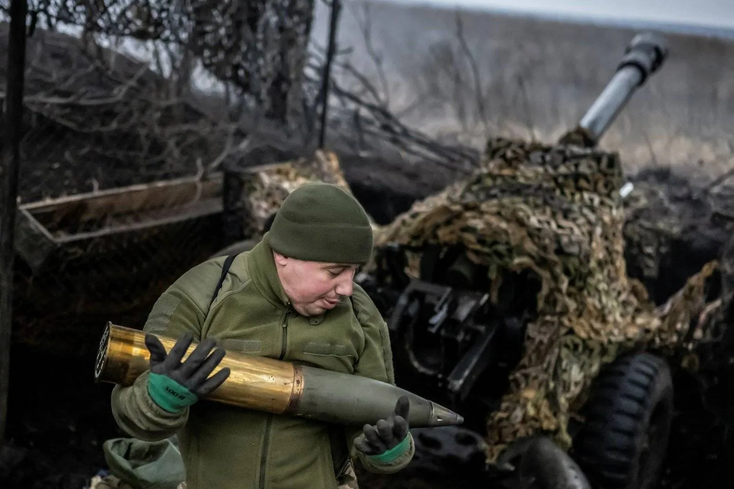 A Ukrainian soldier carries a missile while shooting at Russian forces near Bakhmut (Reuters)