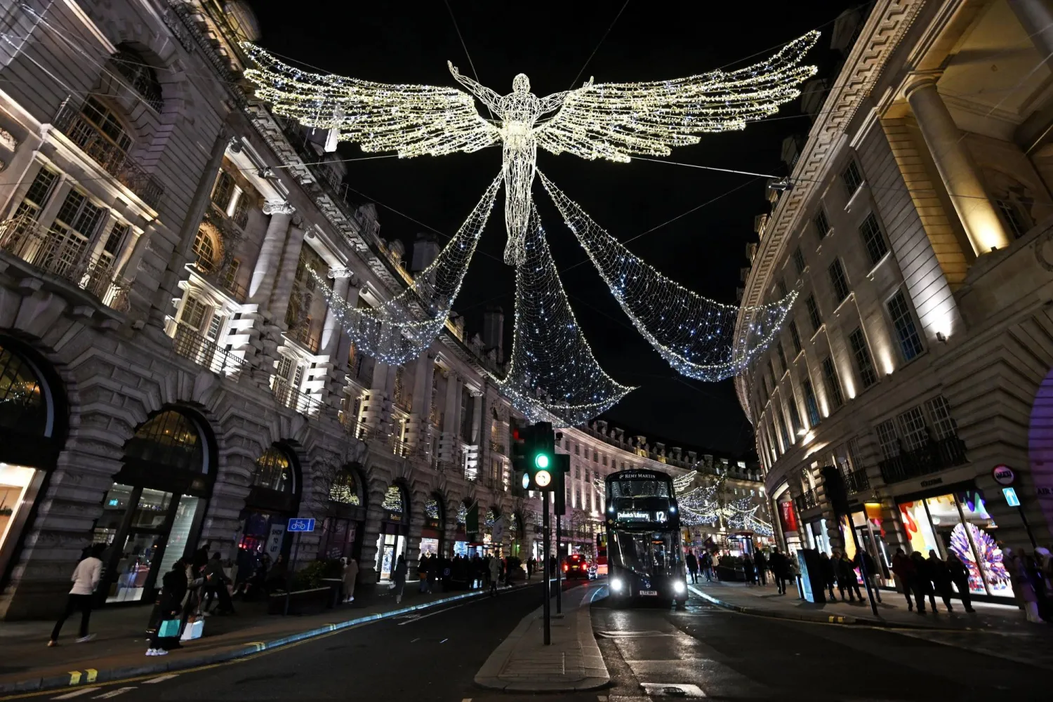Members of the public look at the annual Christmas lights on Regent Street in central London on December 11, 2023. (PHOTO  / AFP)