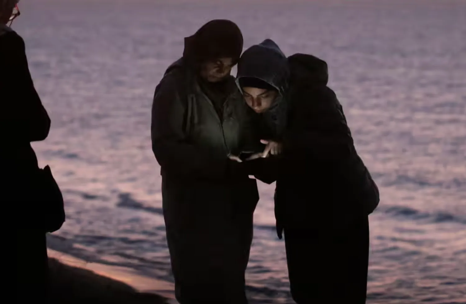Palestinians check the internet with their mobile phones in the central Gaza Strip, 15 December 2023. Photograph: Mohammed Saber/EPA
