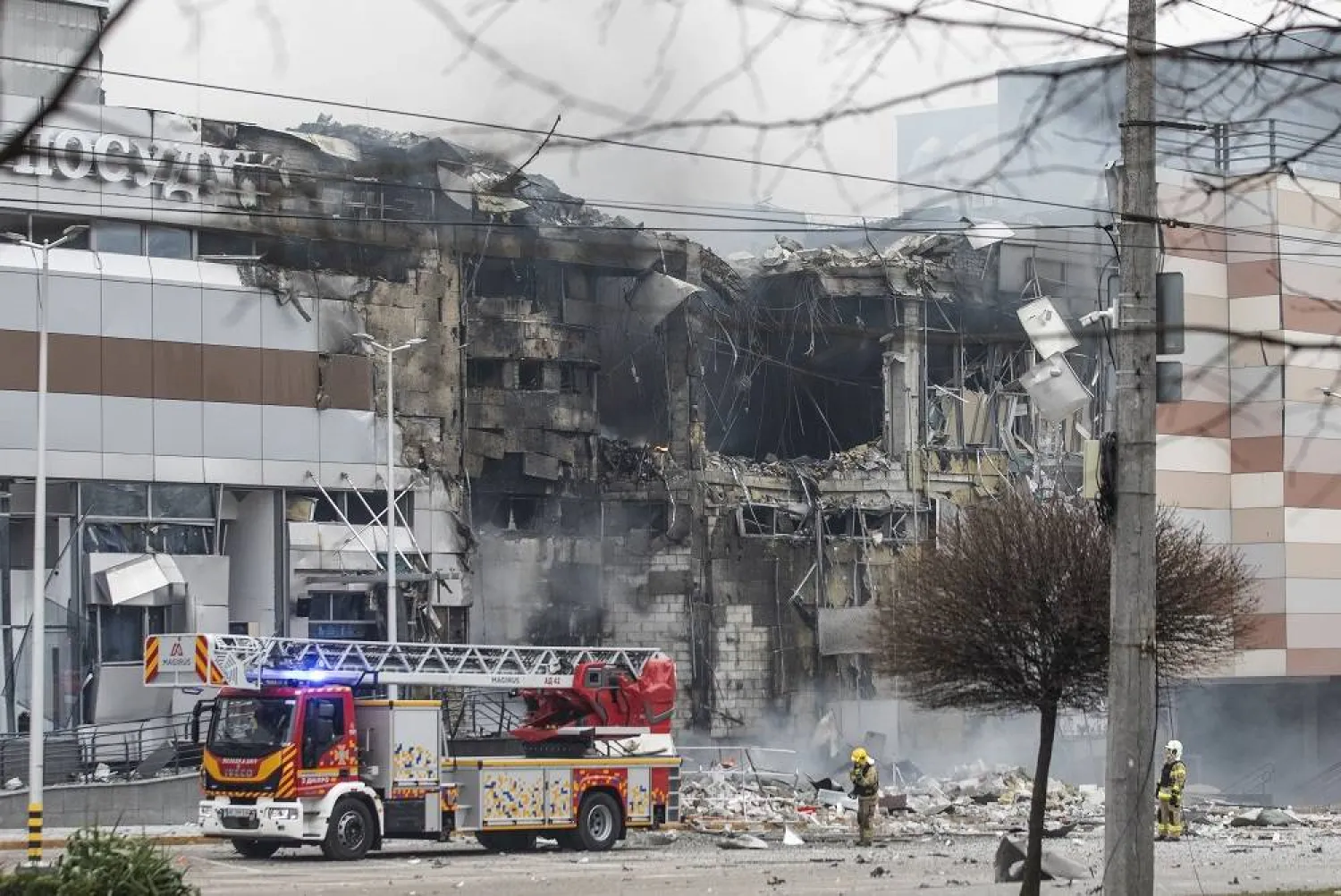 Emergency services work at the site of an overnight rocket attack on a shopping mall in Dnipro, Dnipropetrovsk region, southeastern Ukraine, 29 December 2023, amid the Russian invasion. (EPA)