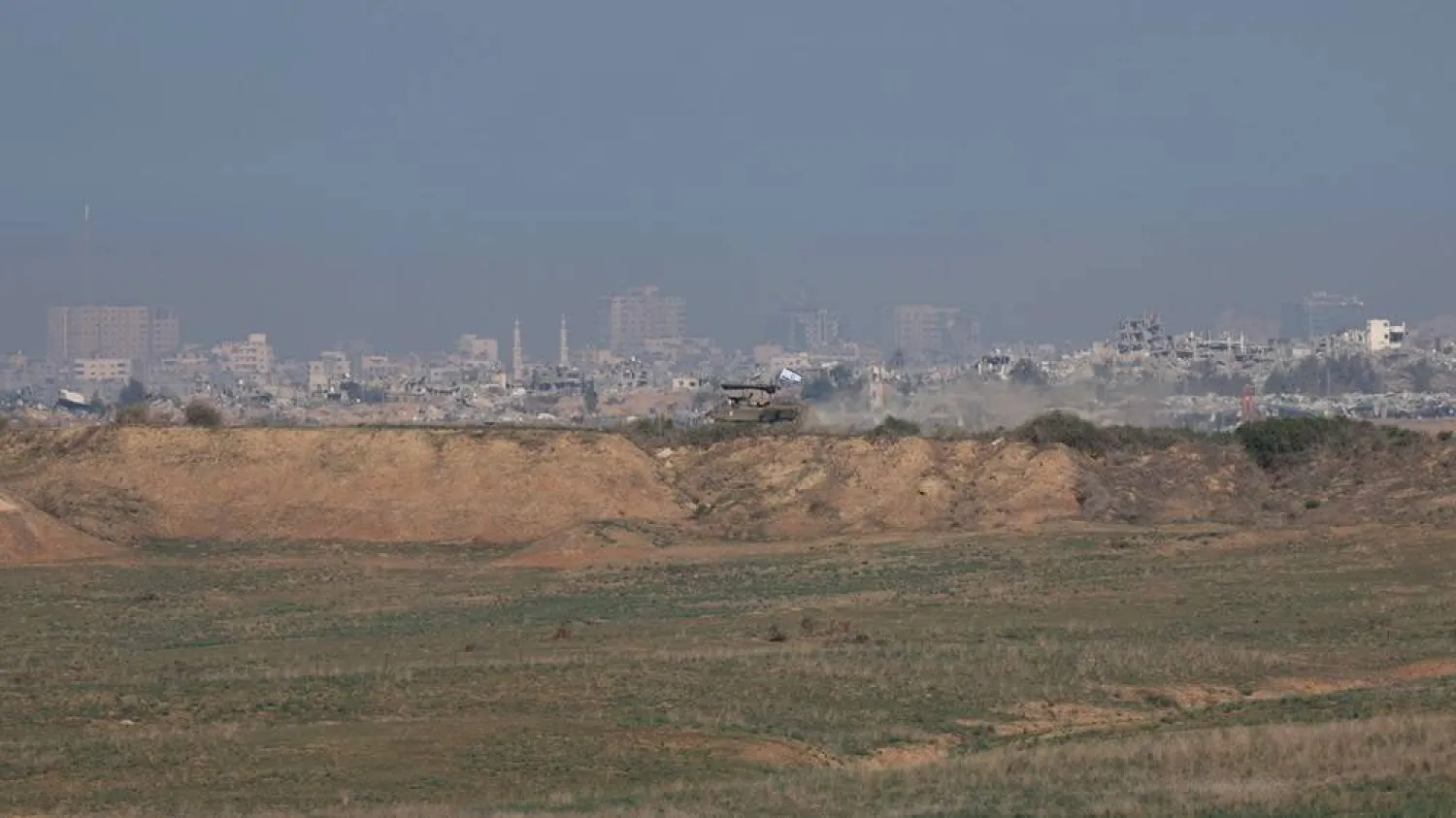 An armored vehicle of the Israeli army patrols an area overlooking the Shujaiya neighborhood in the Gaza Strip, near the Israeli-Gaza border in southern Israel, 30 December 2023. (EPA)