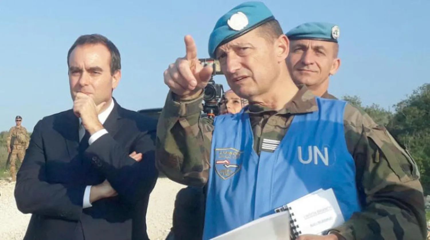The French minister listens to an officer in the French troops during his visit on Saturday (AFP)
			