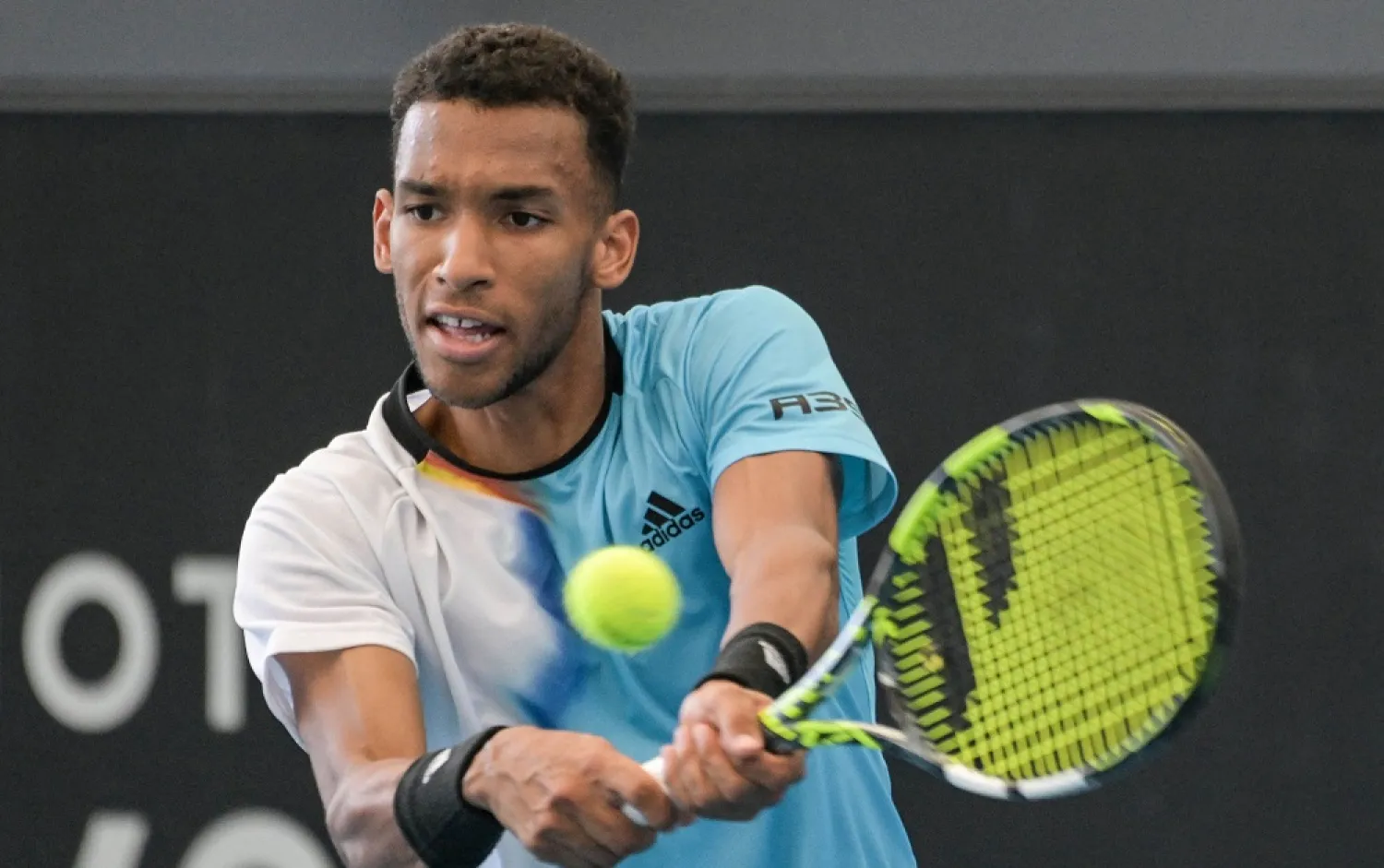 Canada's Felix Auger-Aliassime hits a return against Australia's Alexei Popyrin during their men's singles match at the Adelaide International tennis tournament in Adelaide on January 2, 2023. (AFP)