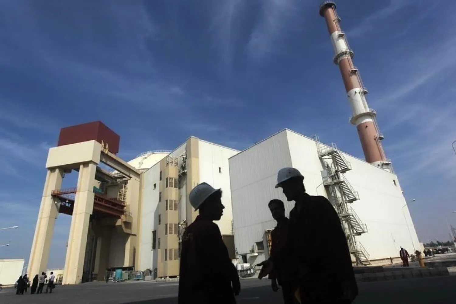 Iranian workers stand in front of the Bushehr nuclear power plant, about 1,200 km (746 miles) south of Tehran October 26, 2010. (Reuters)