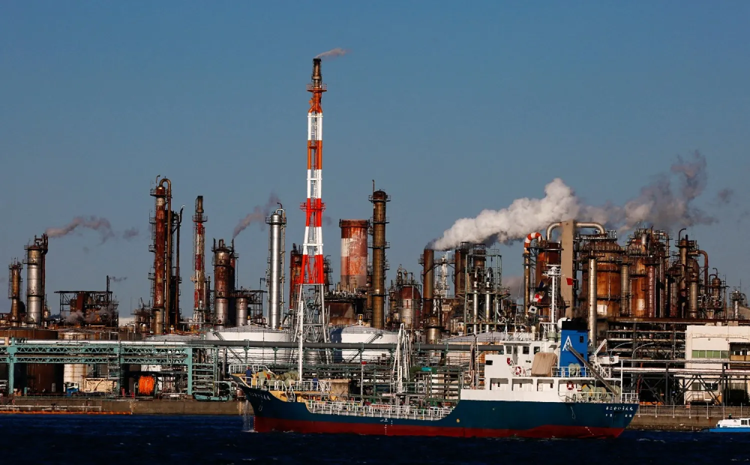 A ship passes a petro-industrial complex in Kawasaki near Tokyo December 18, 2014. (Reuters)