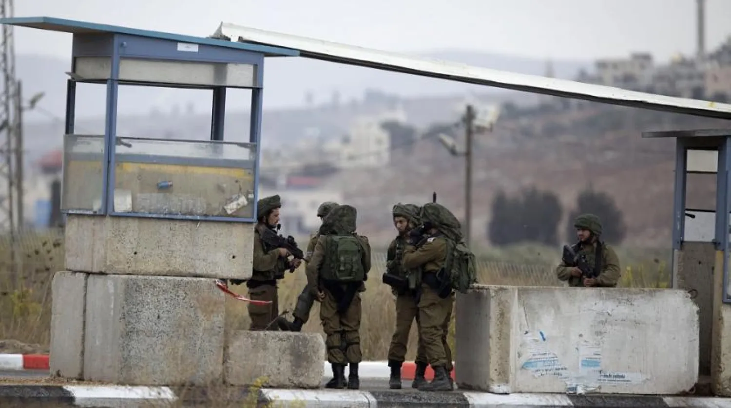 File photo: Israeli soldiers secure the area at the Huwara checkpoint south of the West Bank city of Nablus, Nov. 4, 2020. (AP)
