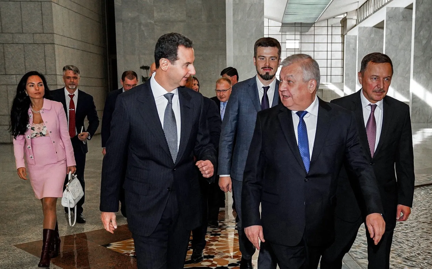 A handout picture released by the official Syrian Arab News Agency (SANA) shows Syria's President Bashar al-Assad (C-L) receiving Russia's Special Envoy for Syria Alexander Lavrentiev (C-R) and his accompanying delegation in the capital Damascus on January 12, 2023. (SANA / AFP)
