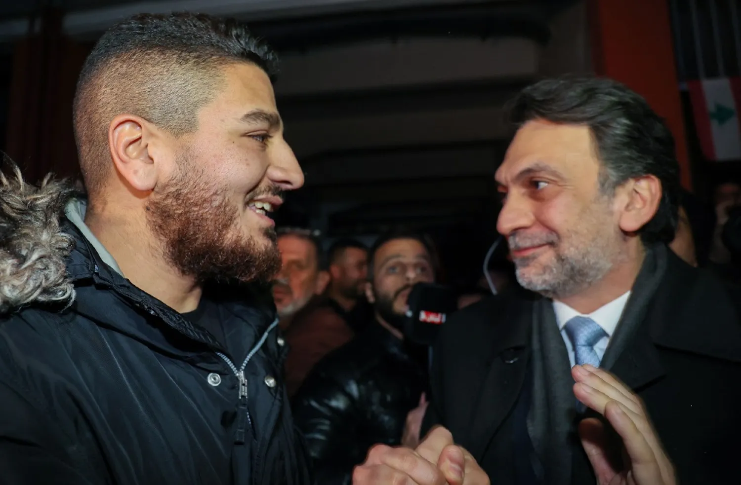 William Noun (L), whose fireman brother was killed in the August 2020 Beirut port blast, is greeted by Lebanese MP Ibrahim Mneimneh upon his release in the capital Beirut on January 14, 2023. (AFP)