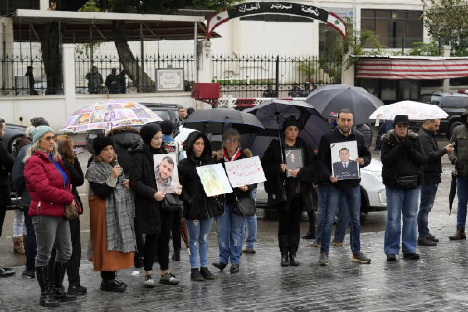 Relatives of the victims of the Aug. 4, 2020, Beirut port explosion hold portraits of their deceased loved ones during a protest in front of a Beirut police barracks in Beirut, Lebanon, Monday, Jan. 16, 2023. (AP Photo/Bilal Hussein)
