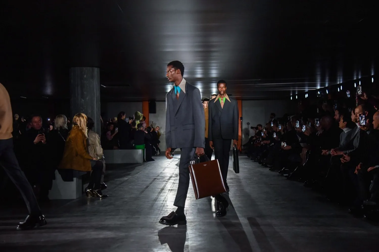 Models present creations from the Fall/Winter 2023 men's collection by Prada at the warehouse of the Prada Foundation during the Milan Fashion Week, in Milan, Italy, 15 January 2023. (EPA)