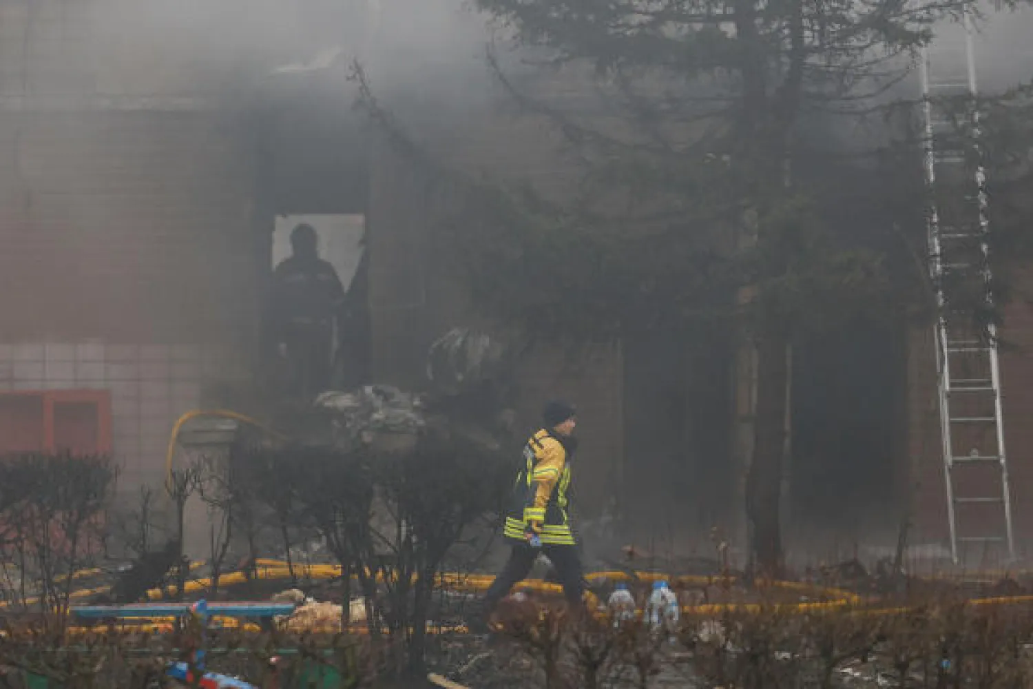 Emergency personnel work at the site of a helicopter crash, amid Russia's attack on Ukraine, in the town of Brovary, outside Kyiv, Ukraine, January 18, 2023. REUTERS/Valentyn Ogirenko
