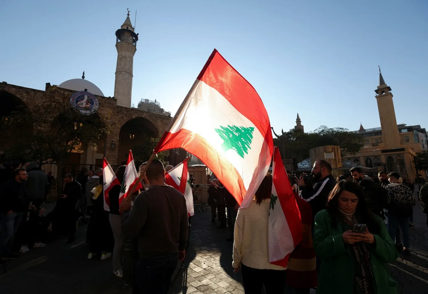 Protesters carry flags near the entrance leading to parliament building, in support of independent lawmakers who are staging a sit-in at parliament to pile pressure on dominant factions to elect a new president, in Beirut, Lebanon January 20, 2023. (Reuters)