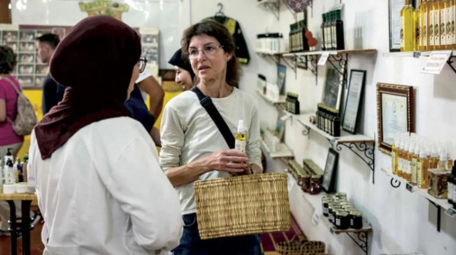 A tourist buys locally-manufactured Argan oil from one of the stores in Moroccan Essaouira (AFP)