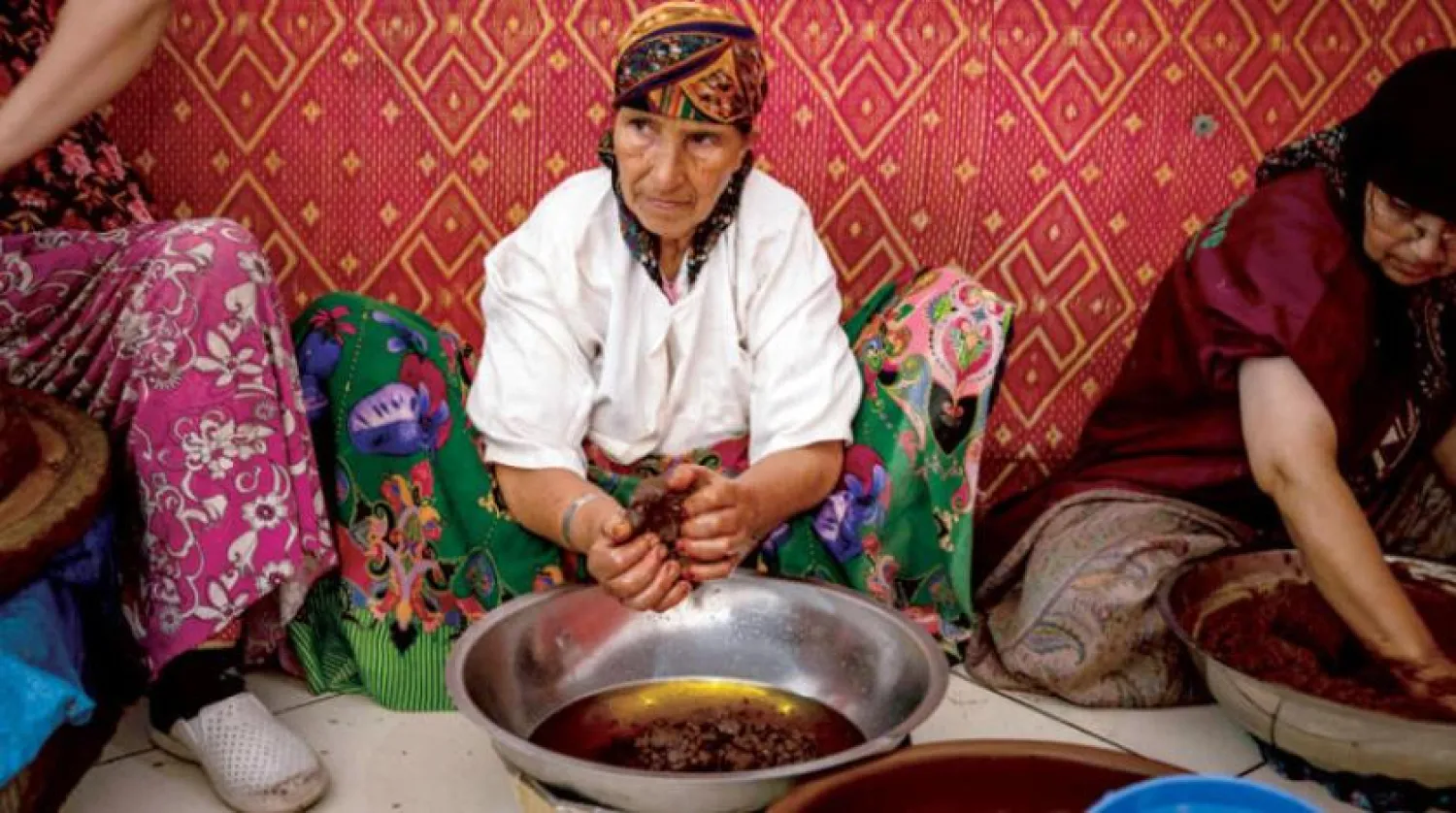 A woman presses seeds to extract argan oil in a city in western Morocco (AFP)

