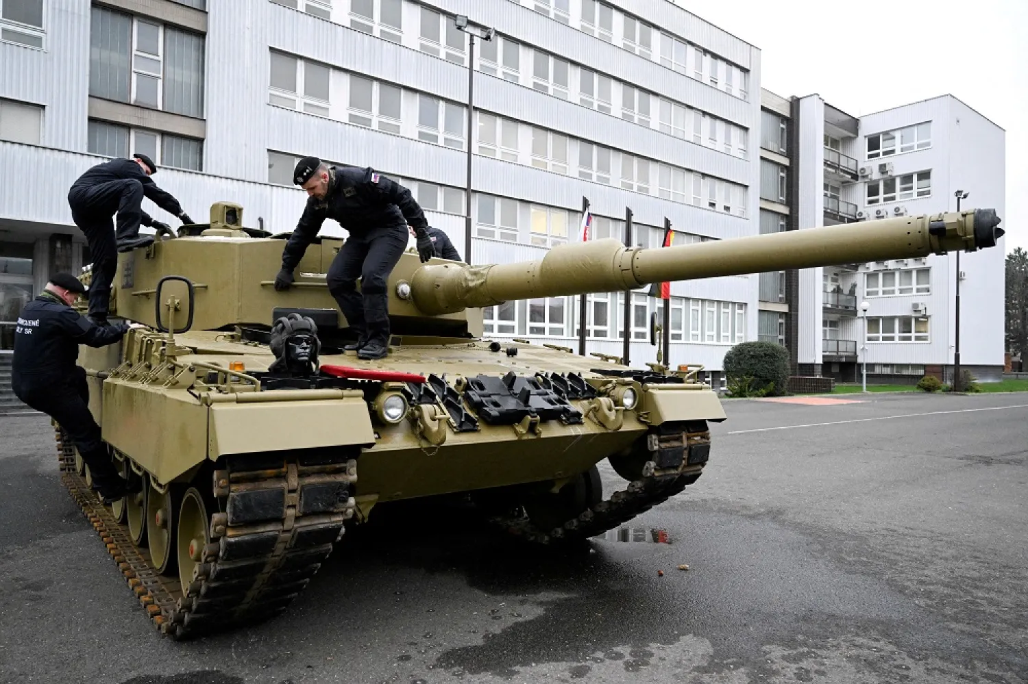 Members of the military walk on a tank, as Germany delivers its first Leopard tanks to Slovakia as part of a deal after Slovakia donated fighting vehicles to Ukraine, in Bratislava, Slovakia, December 19, 2022. (Reuters)