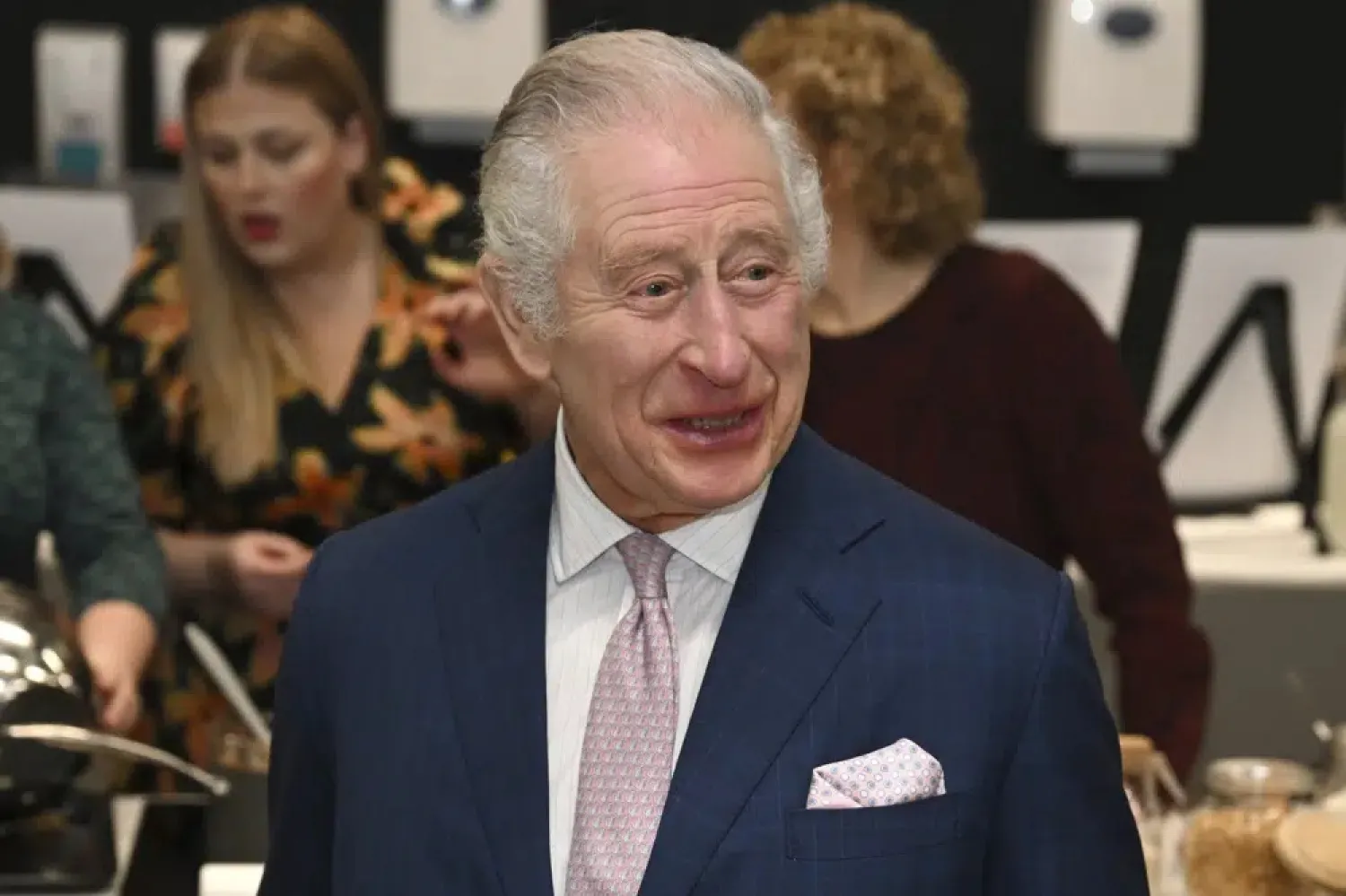 Britain's King Charles III visits the kitchen inside the headquarters of cereal manufacturer Kellogg's marking its 100th anniversary in Manchester, England, Friday Jan. 20, 2023. (AP)