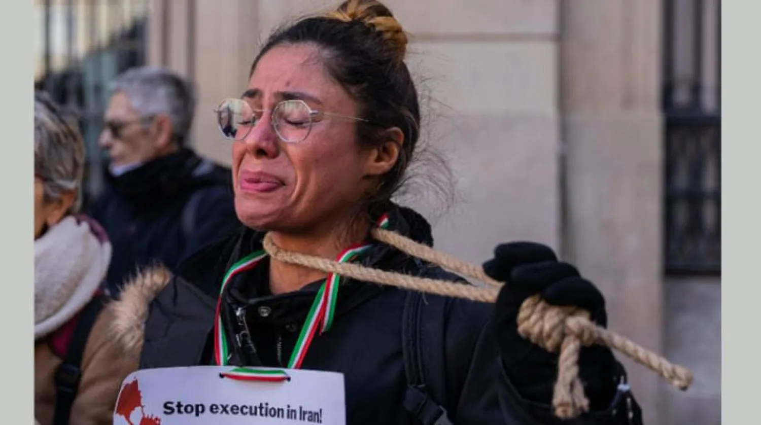 A woman shows solidarity with the Iranians during a stand in Barcelona on Saturday (DPA)